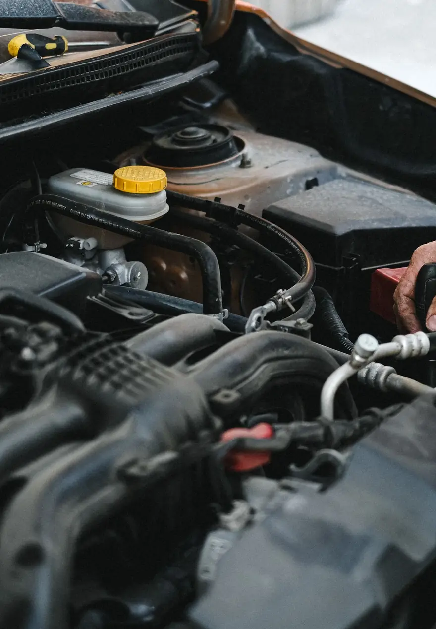Mechanic working under the hood of a car