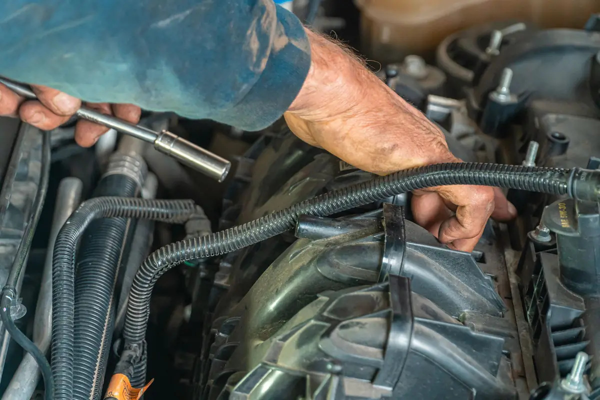Mechanic's hands working on an engine