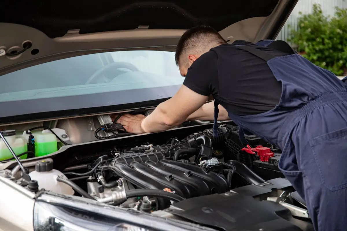 Mechanic leaning into an engine bay